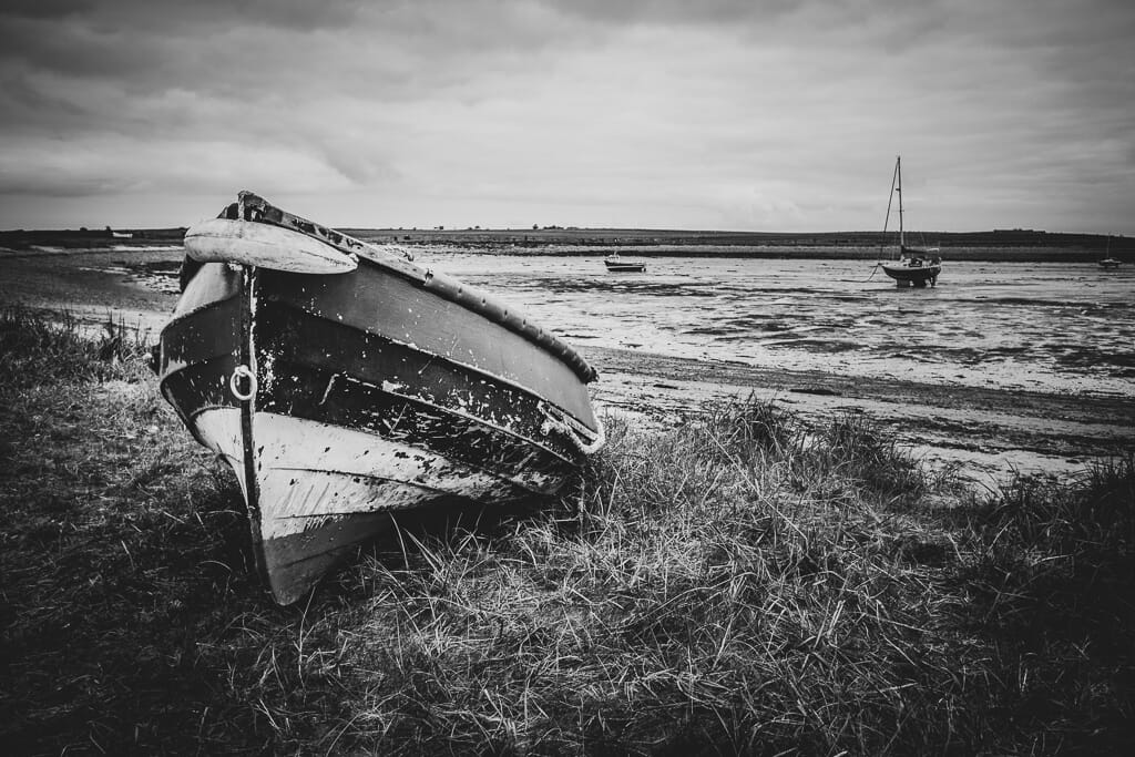 A black and white edit of a seaside boat image
