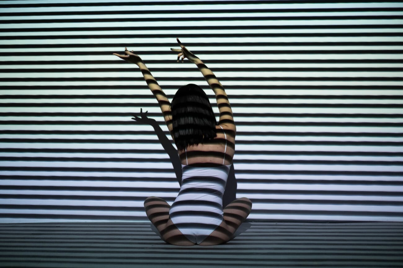 Portrait with geometric shadow patterns across the subject