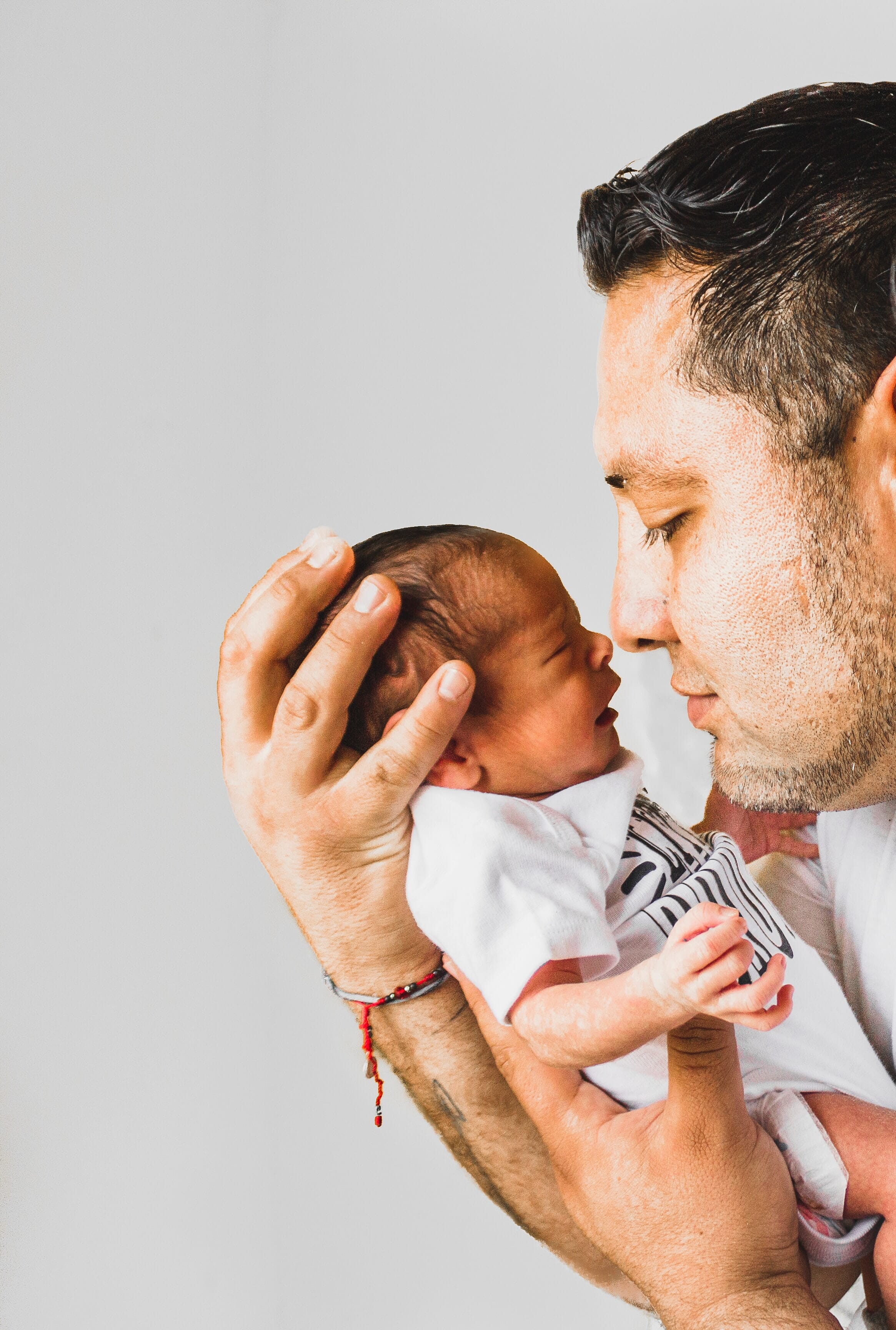 Father and baby touching noses