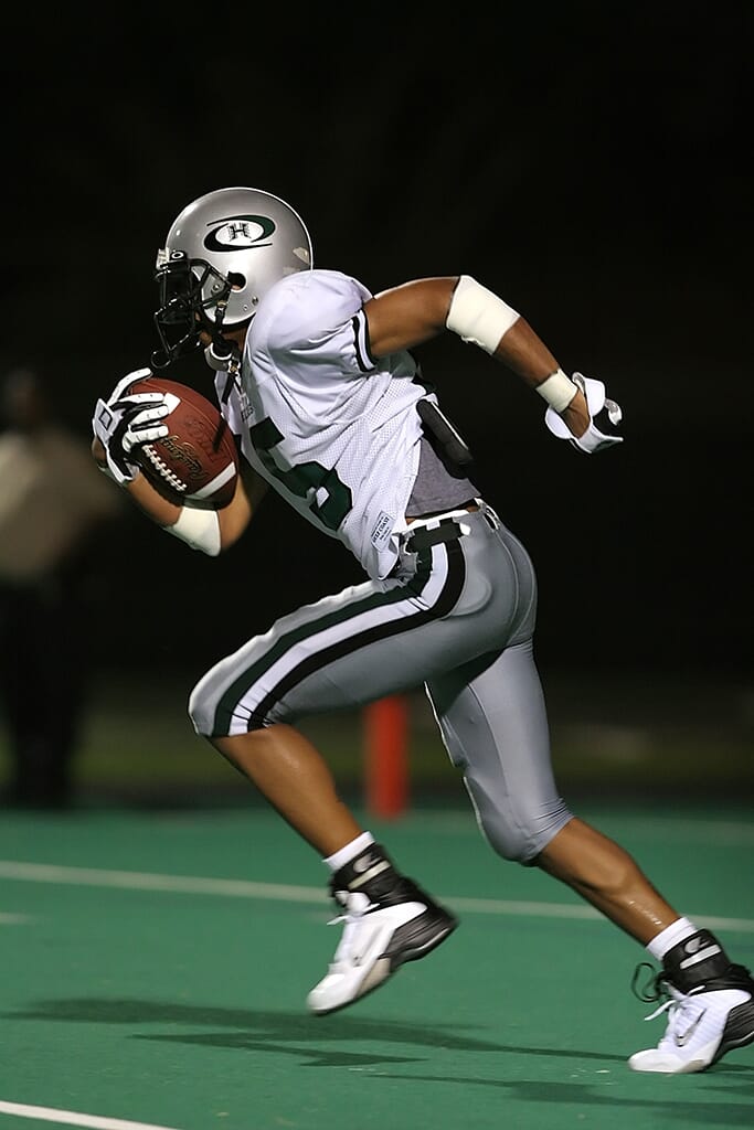 Nikon lenses for sports photography football player running