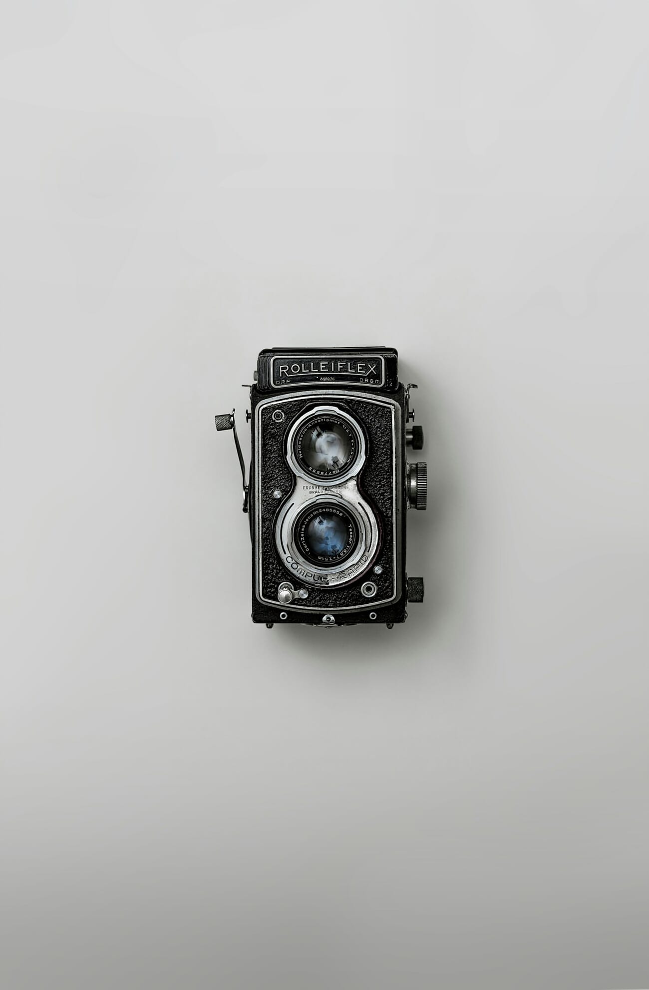 Vintage Rolleiflex twin-lens film camera, product-style shot against a plain background