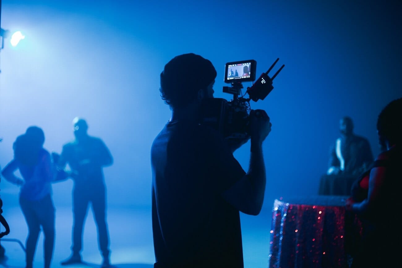A cinematographer on a film set, illustrating traditional camera-based production