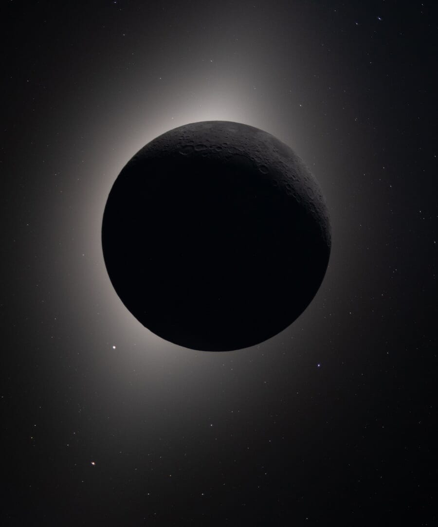 Solar eclipse seen from Orion, with the Moon silhouetted against a corona glow