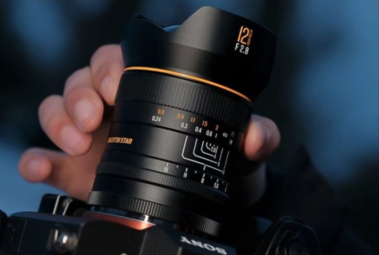 Brightin Star AF 12mm f/2.8 lens for Sony E-mount, side profile showing the bulbous front element and weather-sealed barrel