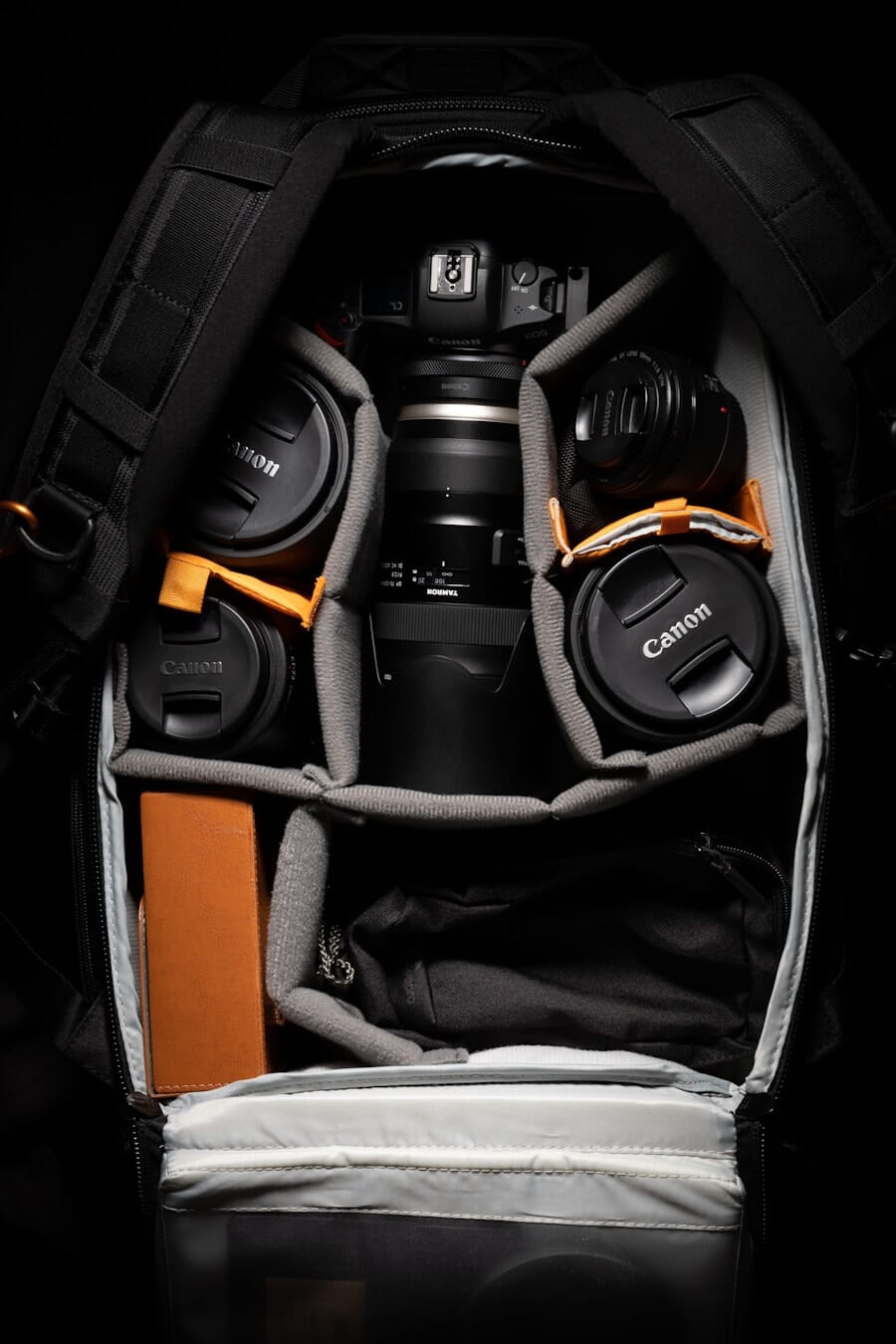 A bag of camera gear and accessories laid out
