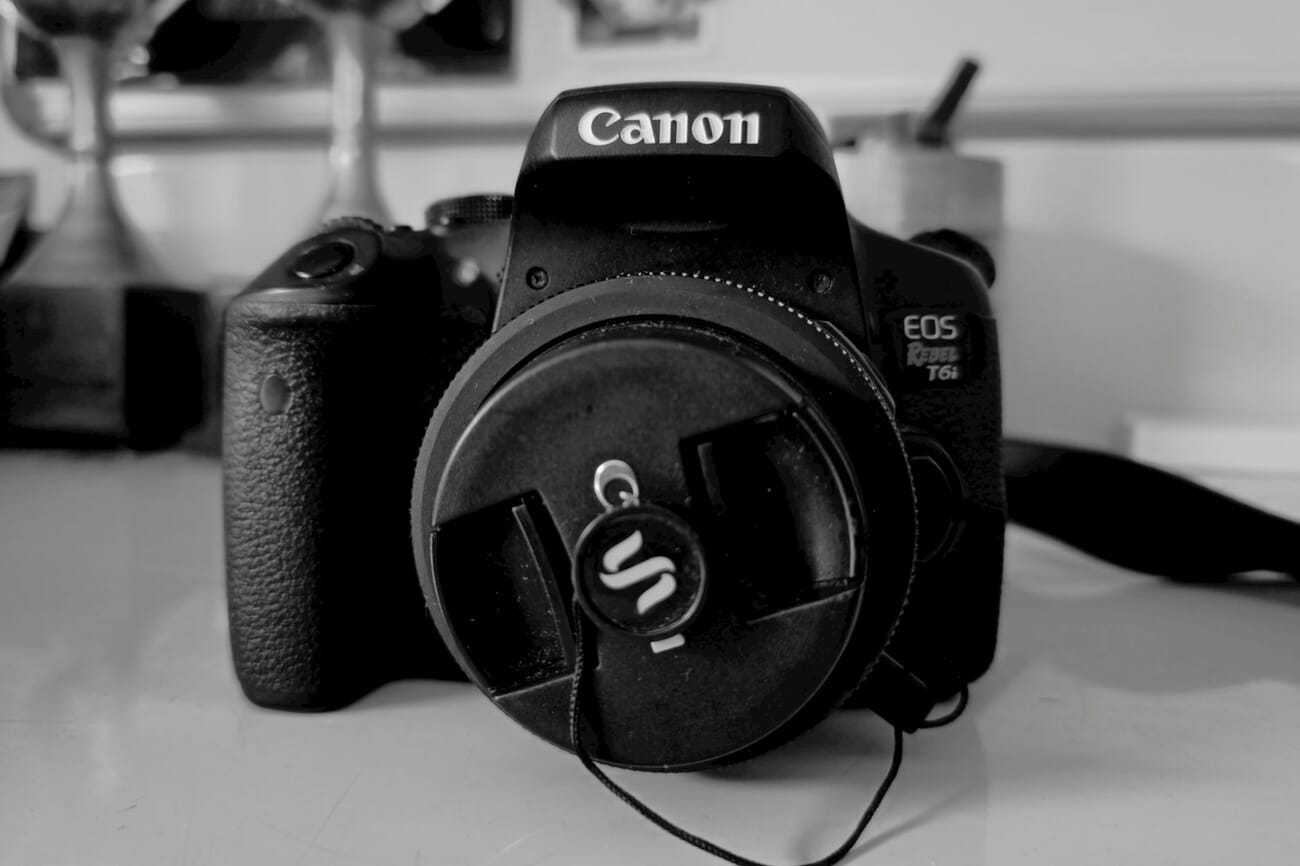 Canon EOS body on a clean surface — representing the camera-side of the authenticity stack, signing photos cryptographically at capture