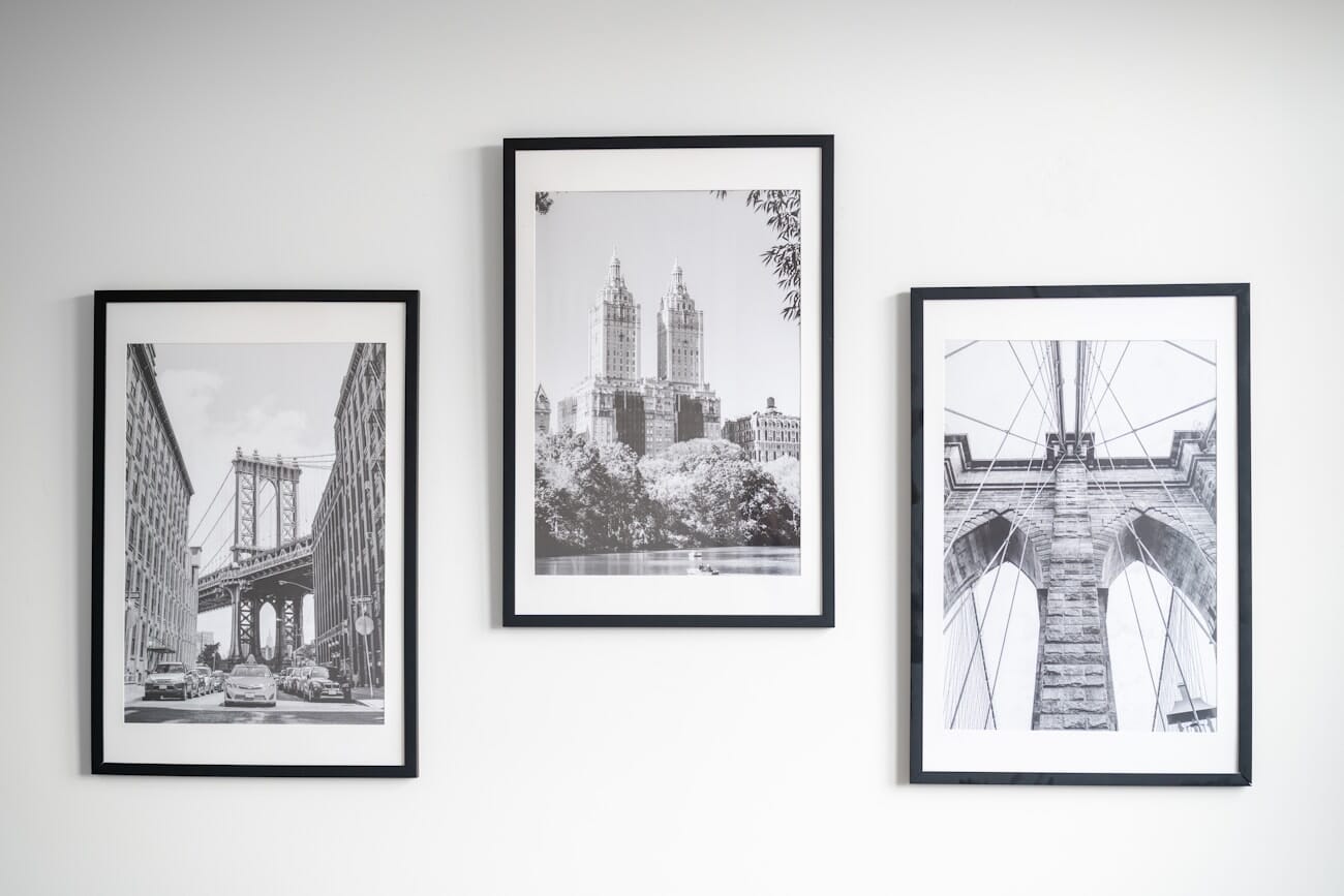 Framed black-and-white photographs displayed on a gallery wall.