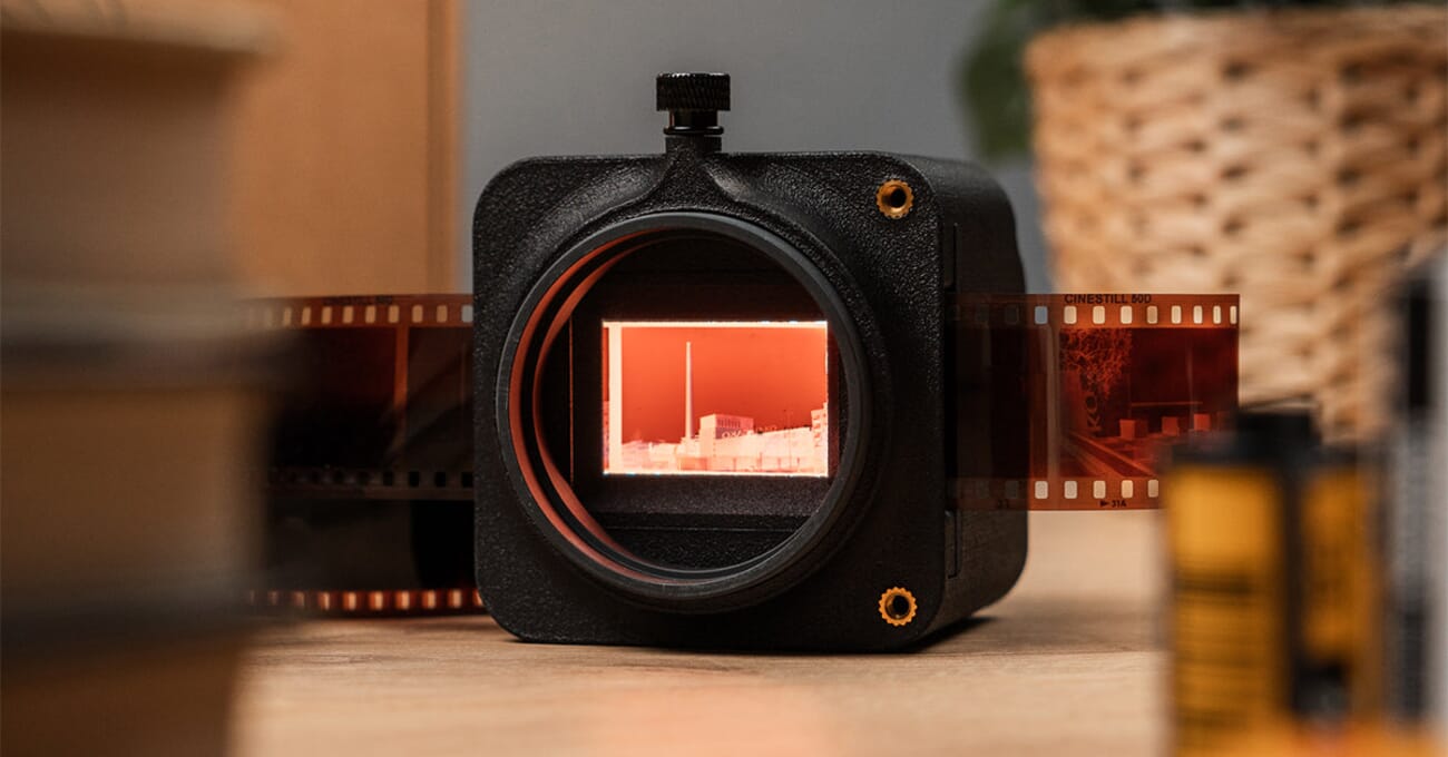 The Valoi easy35 v2 film scanner with a CineStill 50D negative strip loaded and backlit