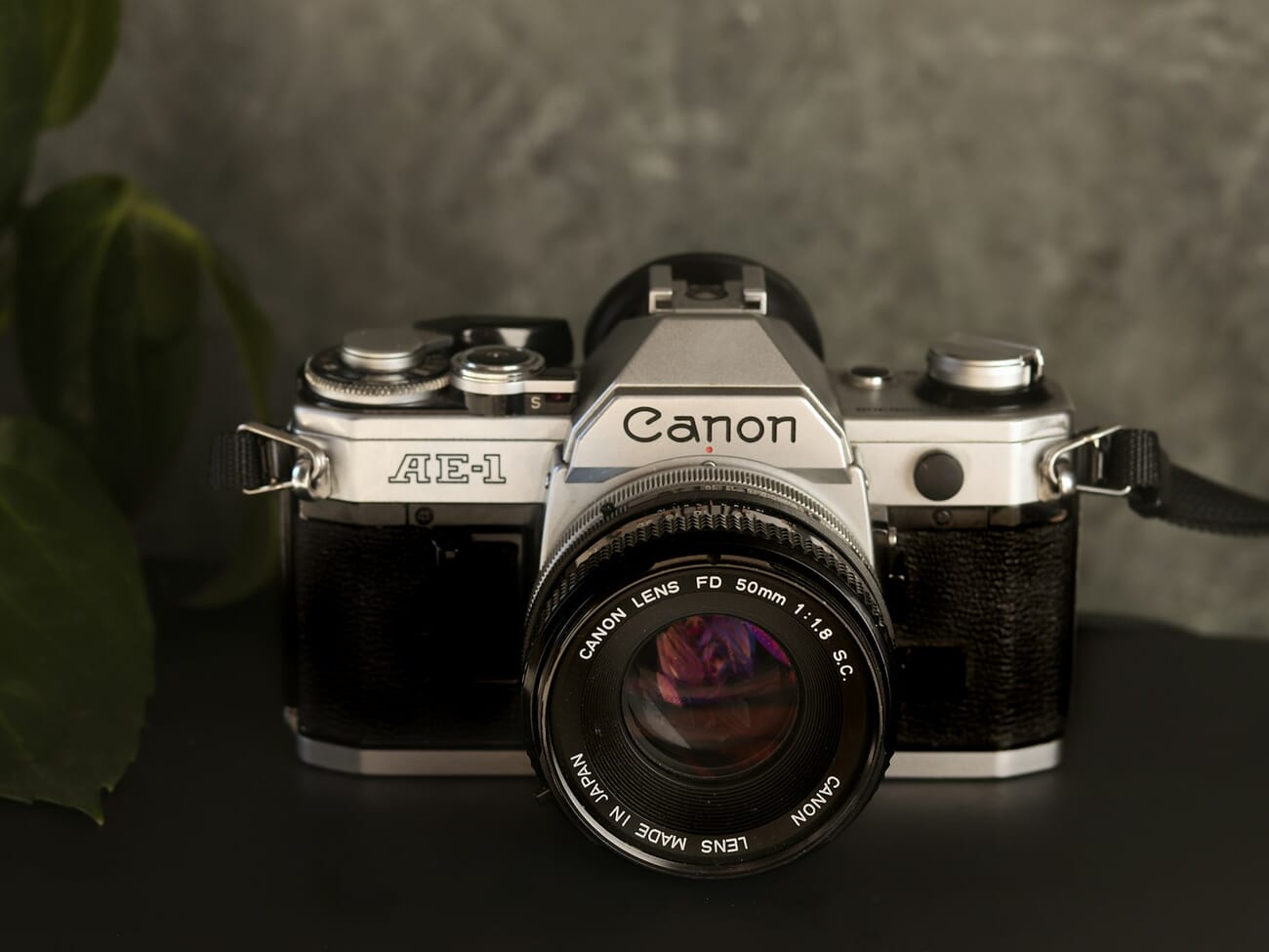 A classic silver-and-black Canon AE-1 film SLR with an FD 50mm f/1.8 lens