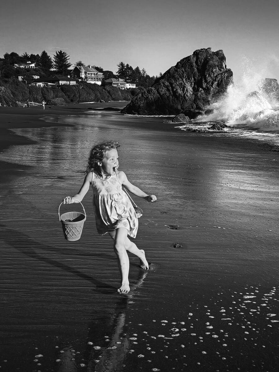 Children category winner, a girl running on the beach with a bucket by Krystal Rountree