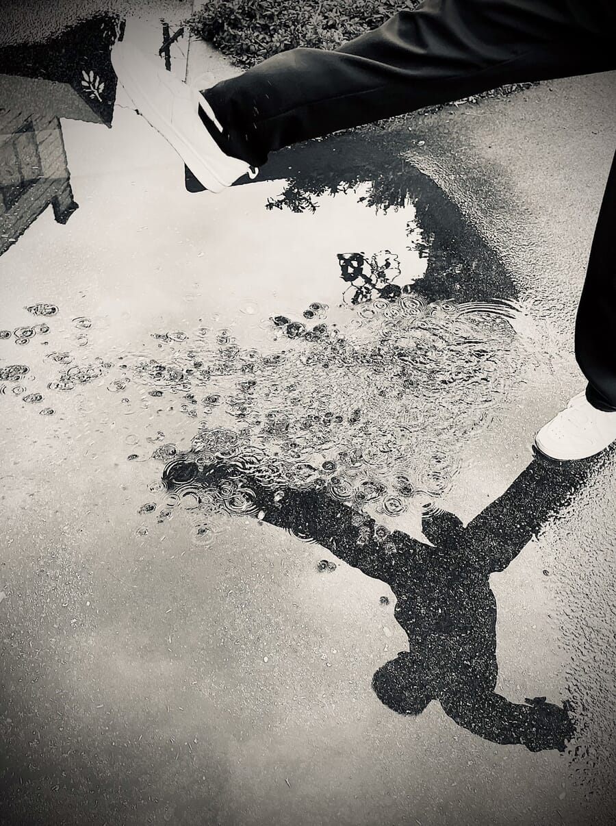 People category winner, a puddle reflection of a passerby in San Francisco by Jenny Dang