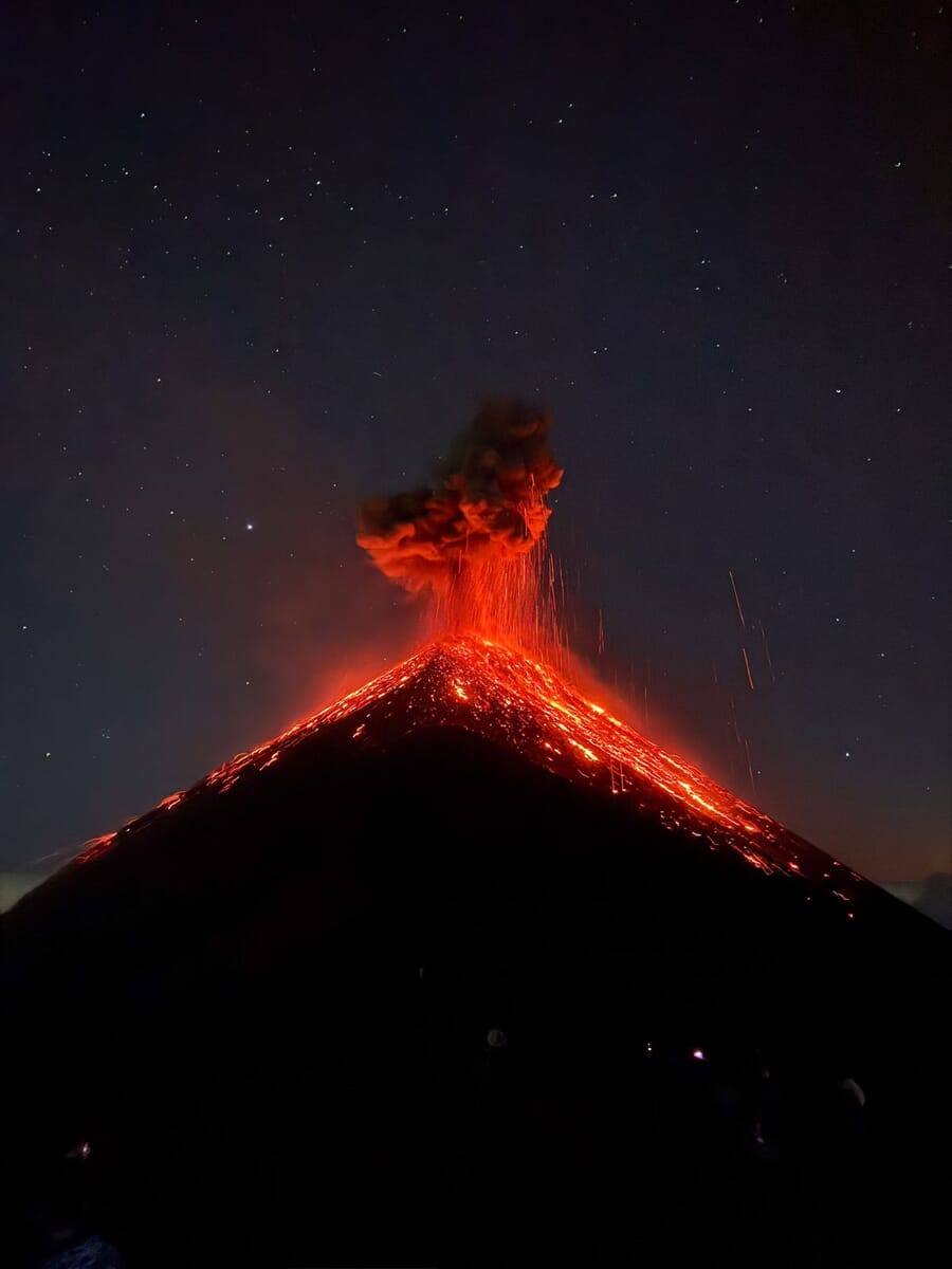 Grand Prix winning photo of the 2026 iPhone Photography Awards: an erupting volcano at night in Yepocapa, Guatemala, with glowing lava under a star-filled sky, shot on an iPhone 15 Pro
