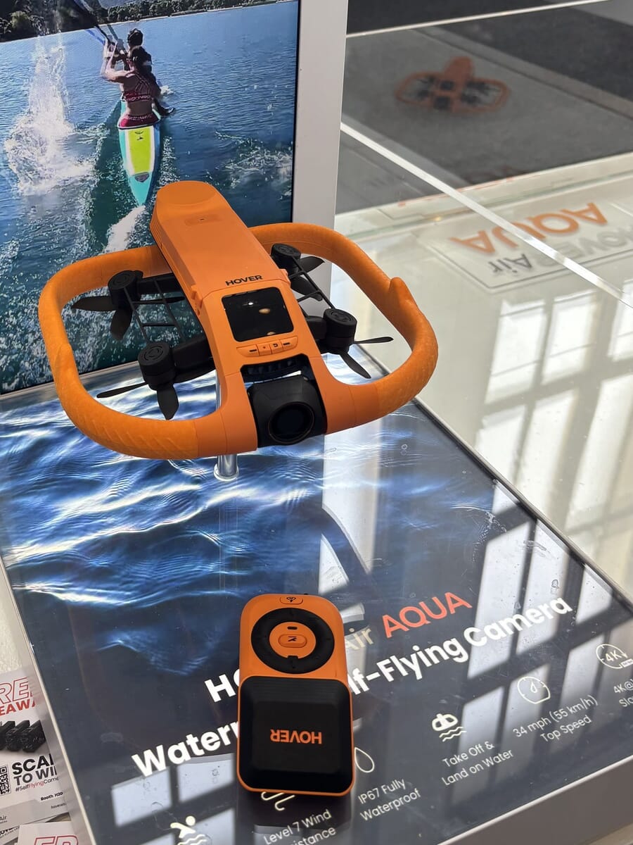 The orange HoverAir Aqua waterproof drone on display at IFA 2026 next to its spec banner