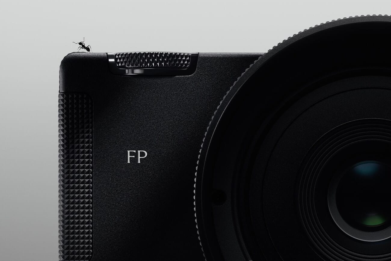 Close-up of the Sigma FP2 showing its textured grip, FP logo and lens, with an ant for scale