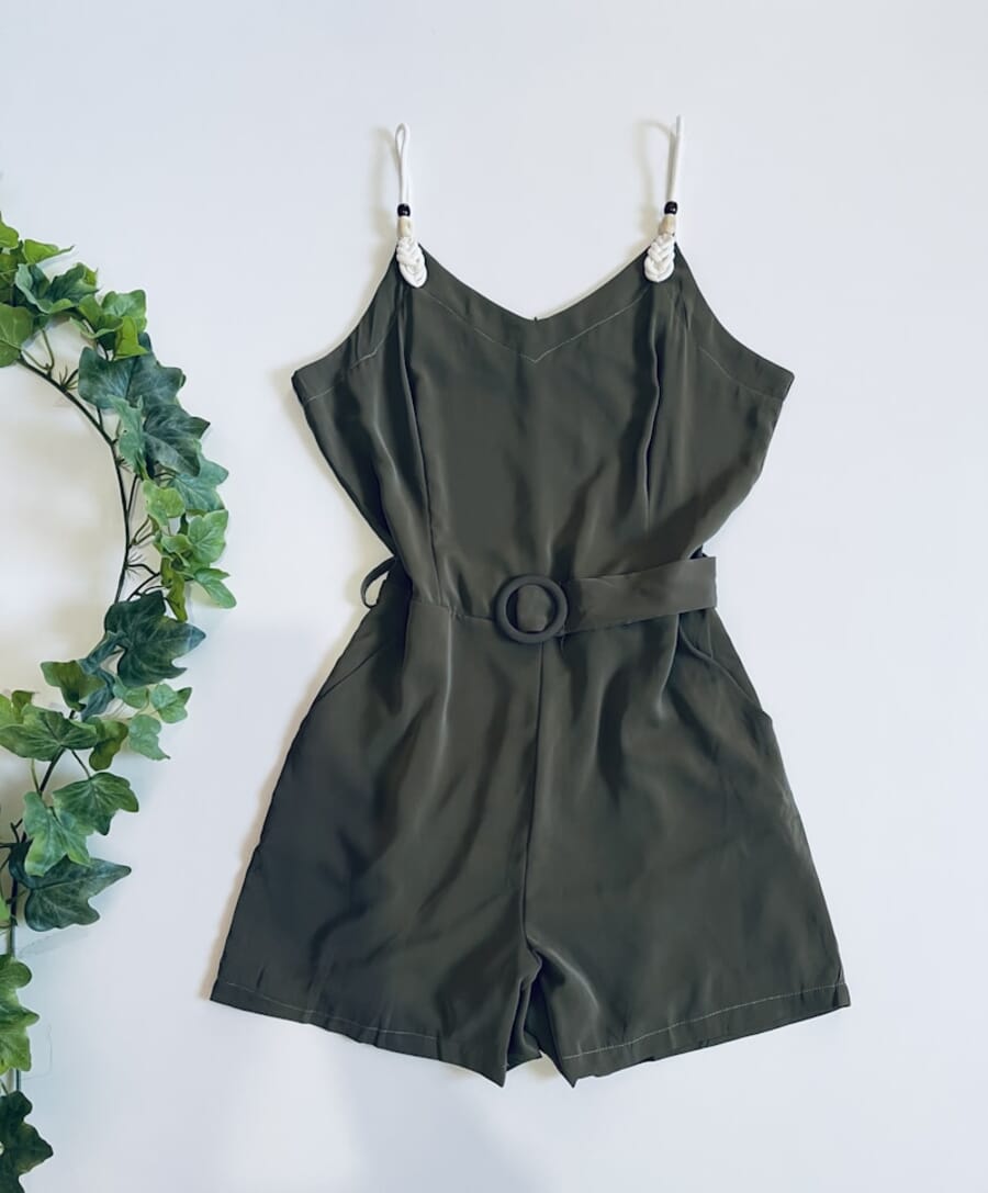 Green sleeveless dress on hanger - original flat lay photo