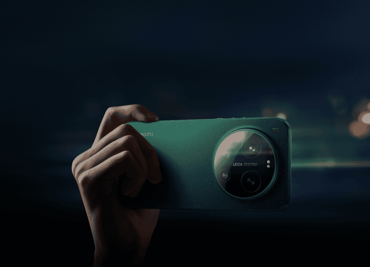 Hand holding Xiaomi 17 Ultra at night with bokeh city lights in the background