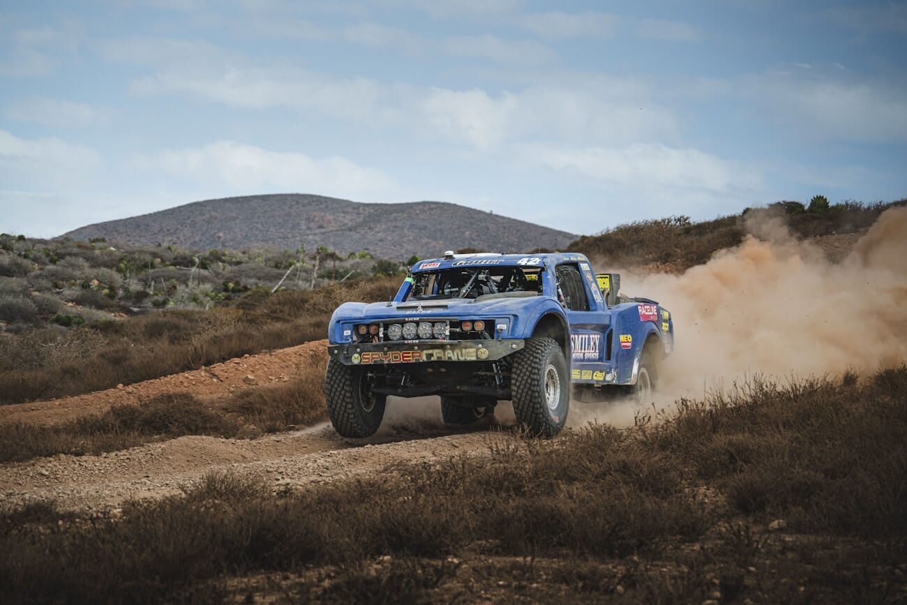 Off-road truck kicking up dust during a desert race, shot on Nikon Z8 at 165mm f/7.6 1/1250s