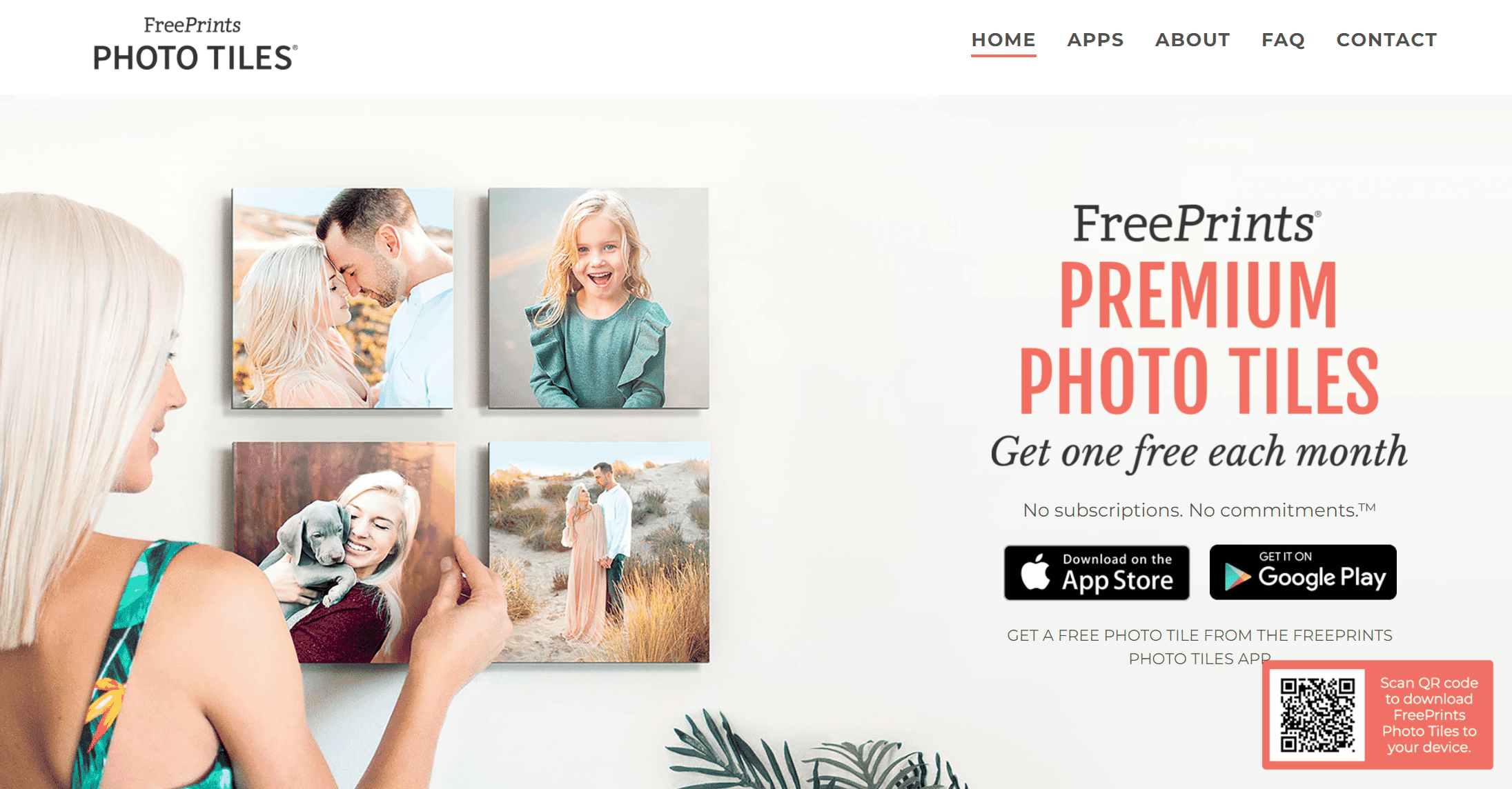 FreePrint home page showing a woman hanging photo tiles on a wall.