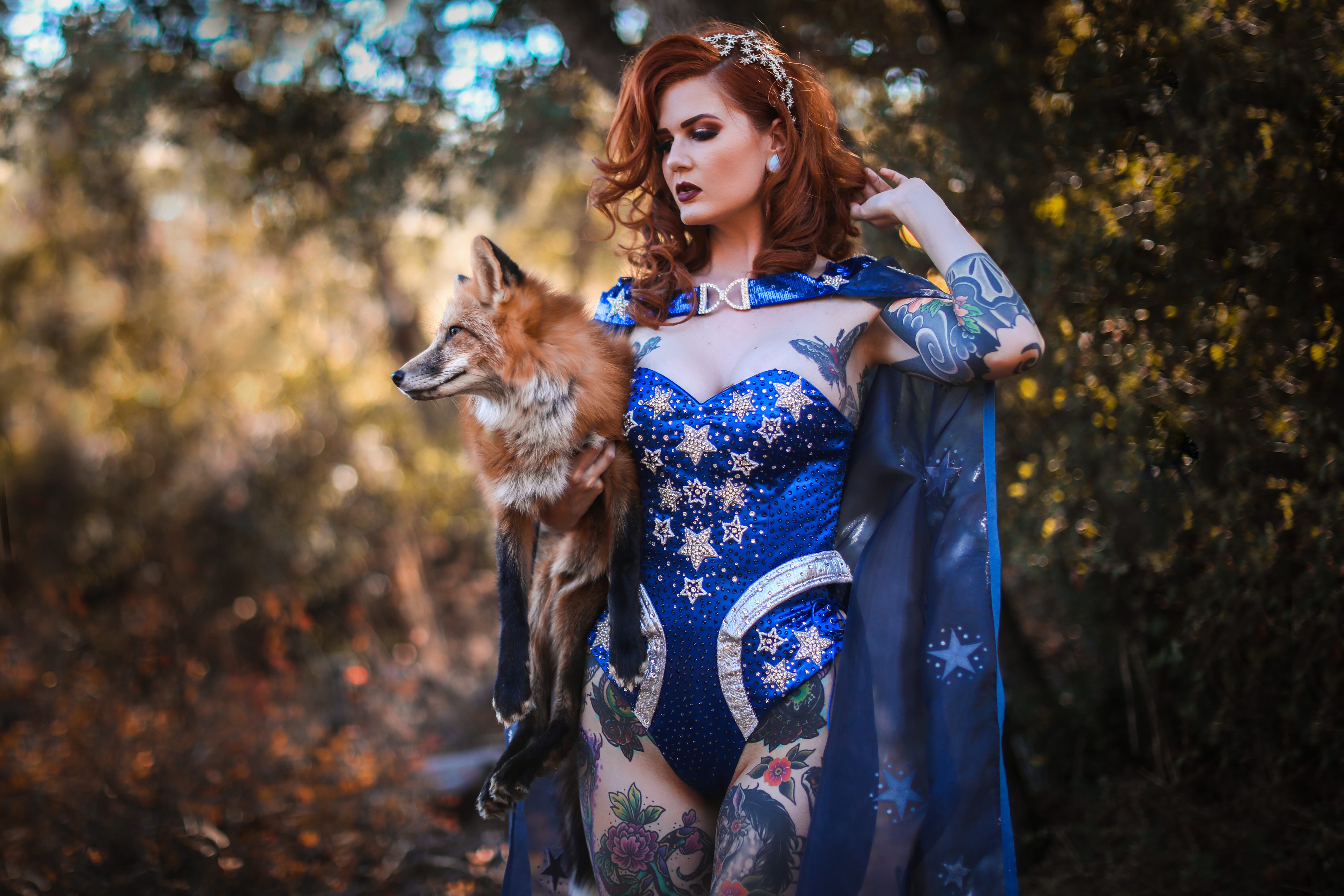 Model posing with a fox