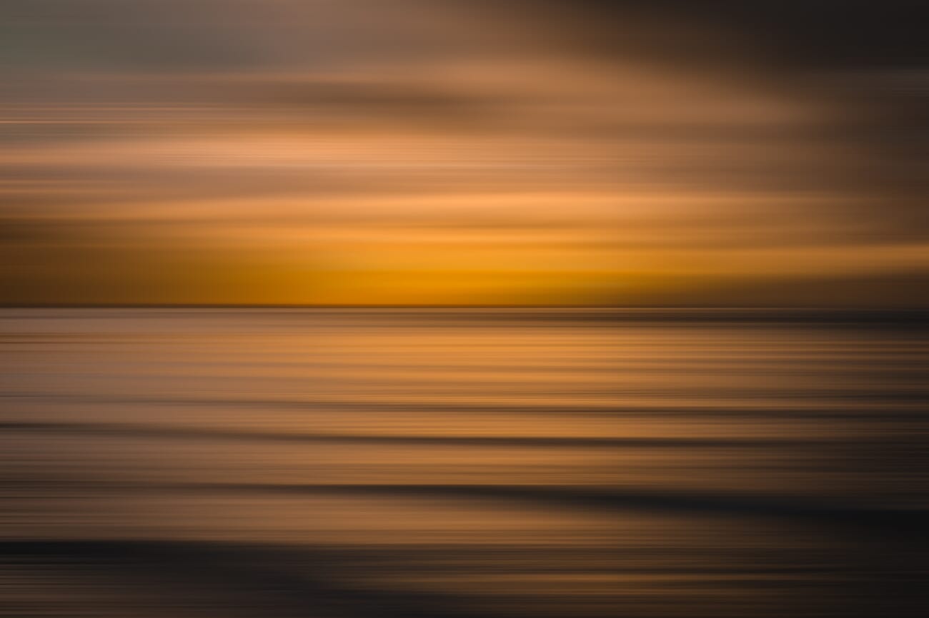 Intentional camera movement of water at sunset with soft dreamy blur