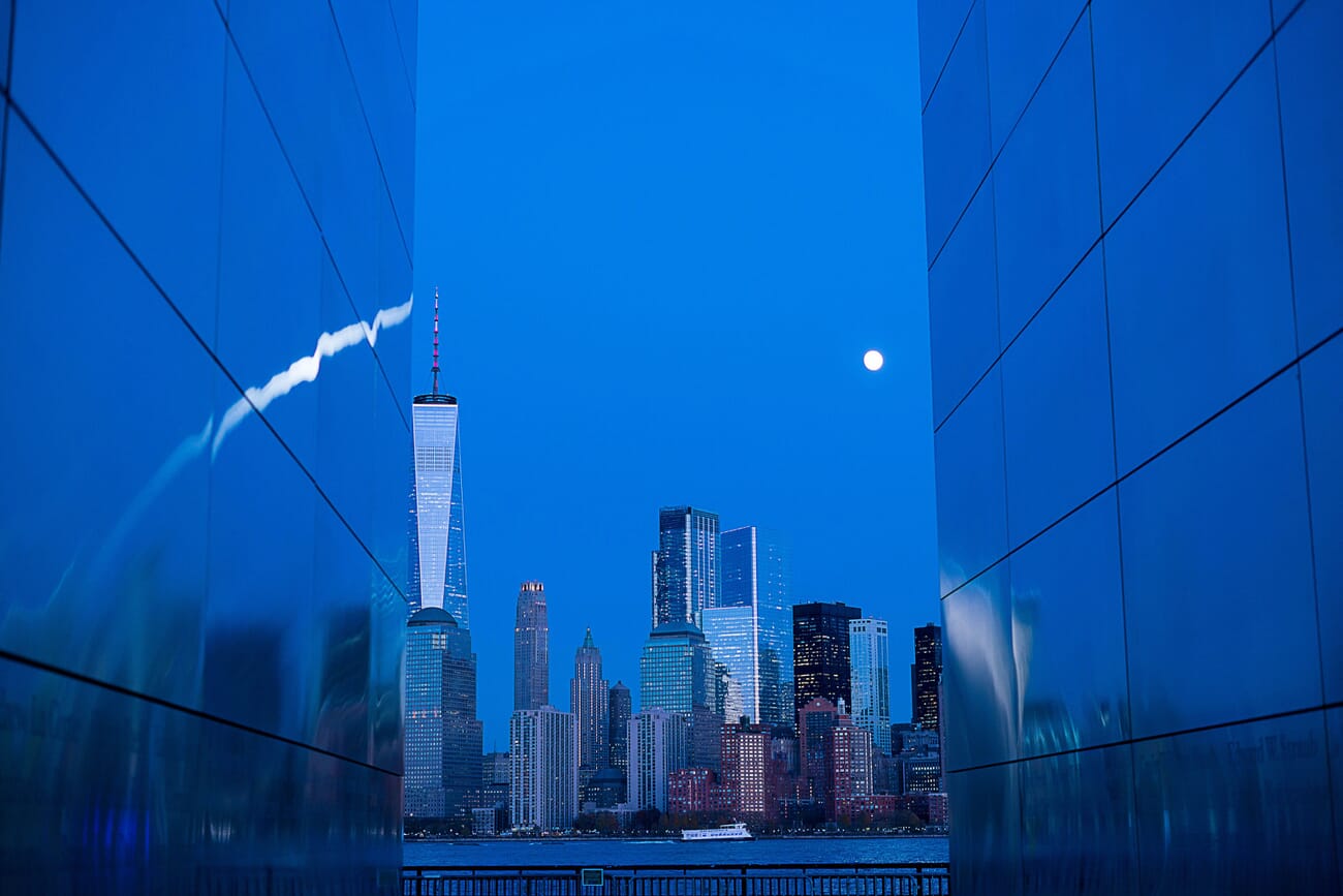 Blue hour cityscape with deep blue sky and warm window lights