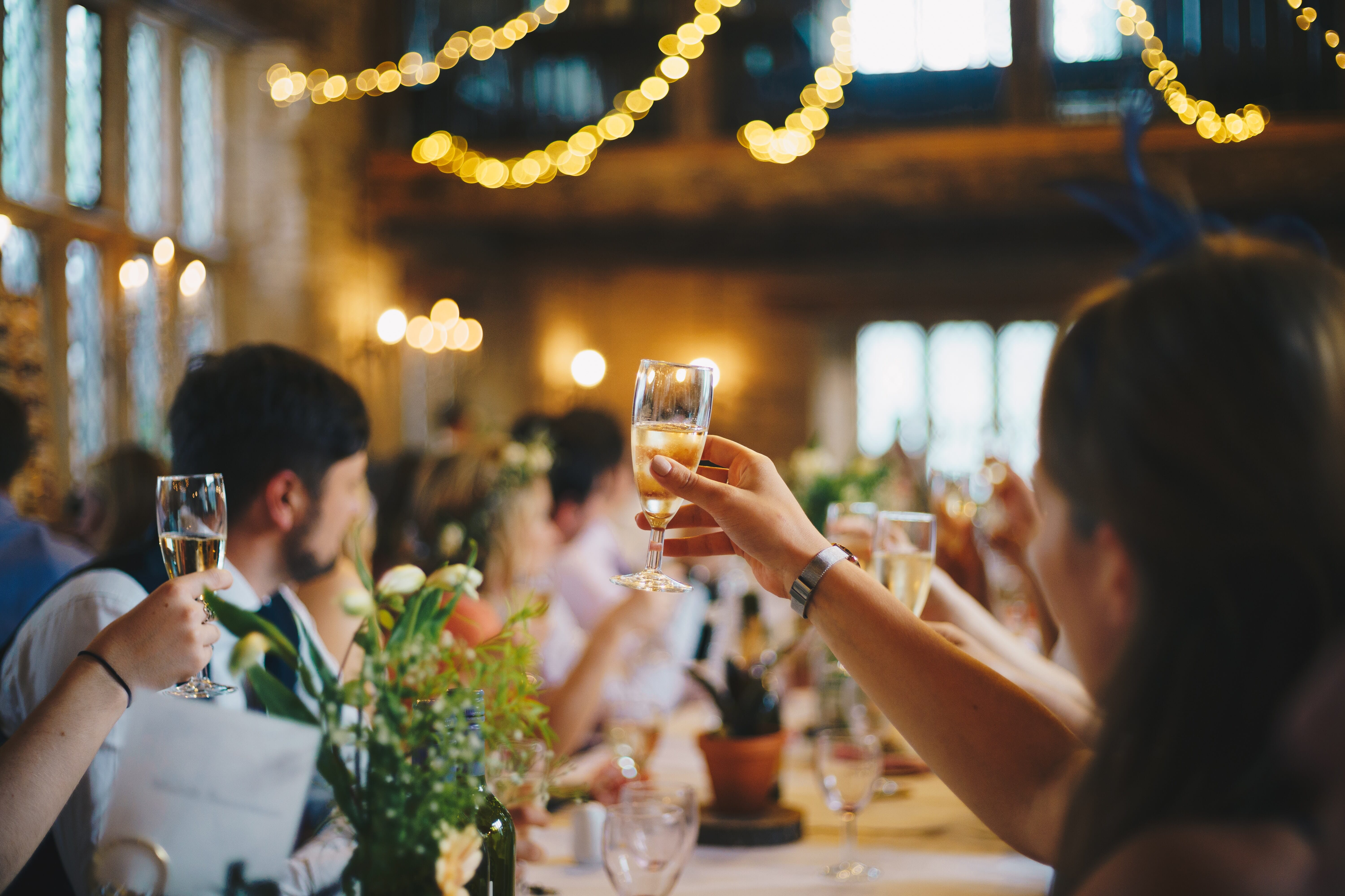 person raising a glass at a reception