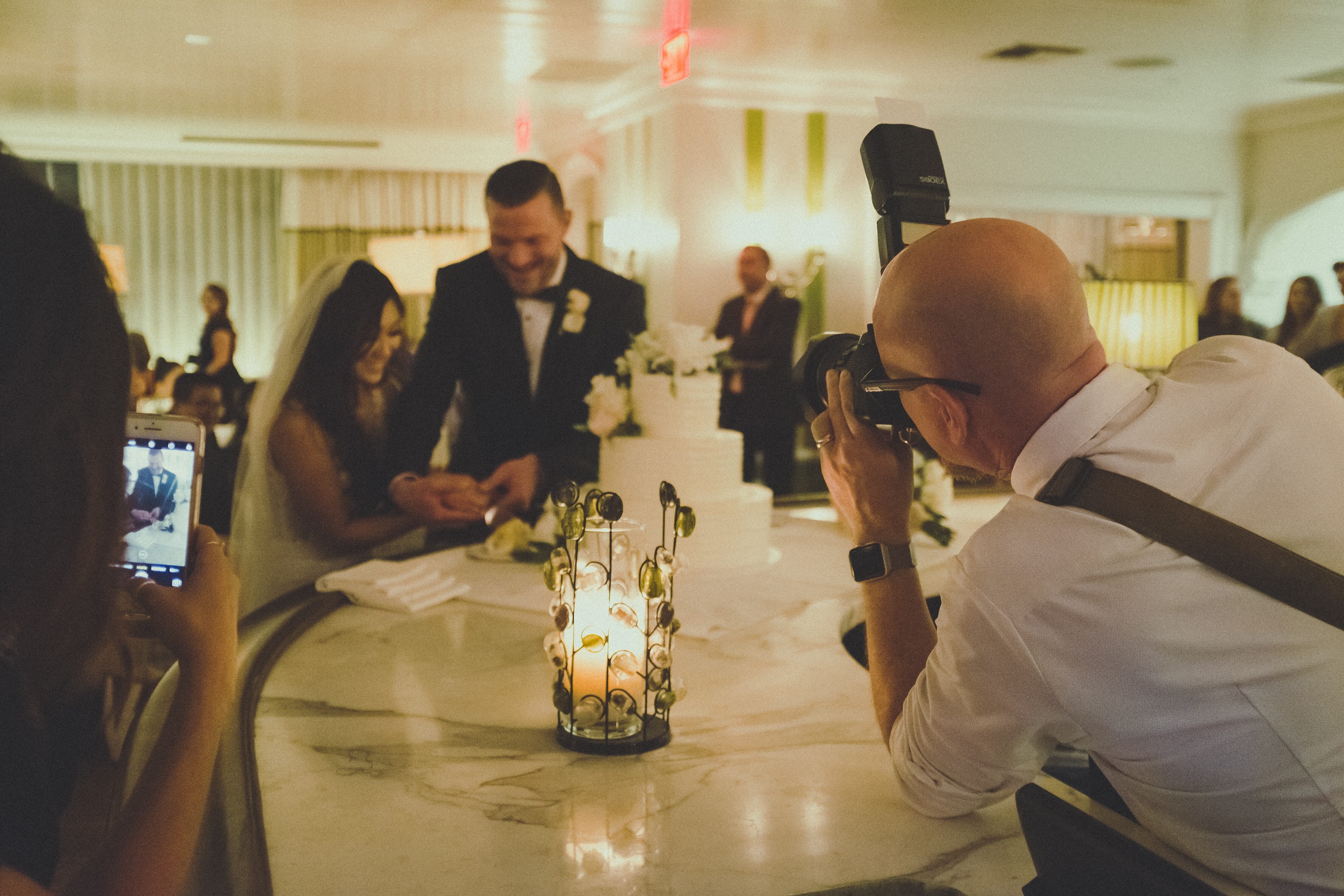 photographer capturing a couple at a wedding reception