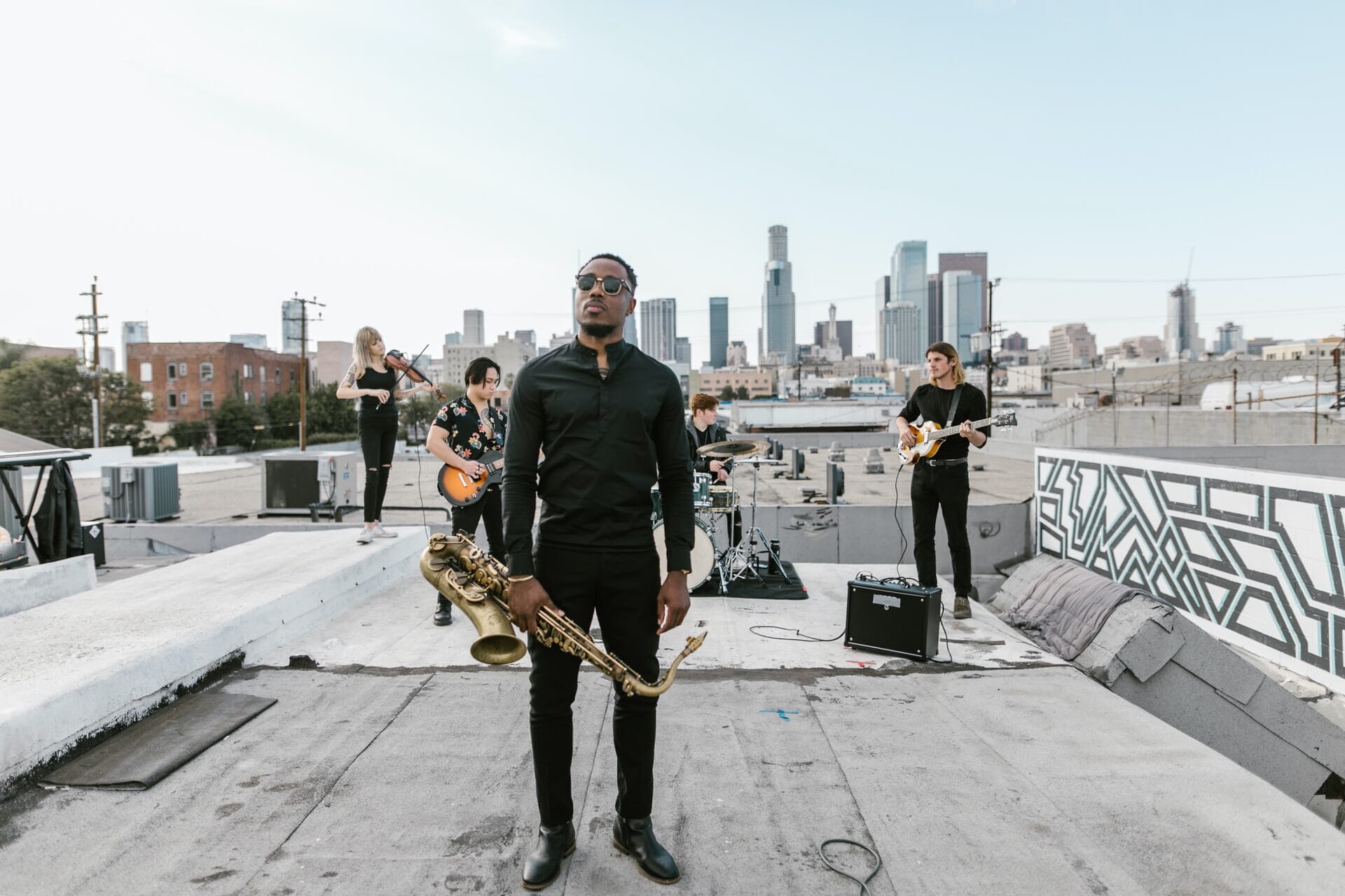 Band photoshoot on warehouse roof with cityscape in background