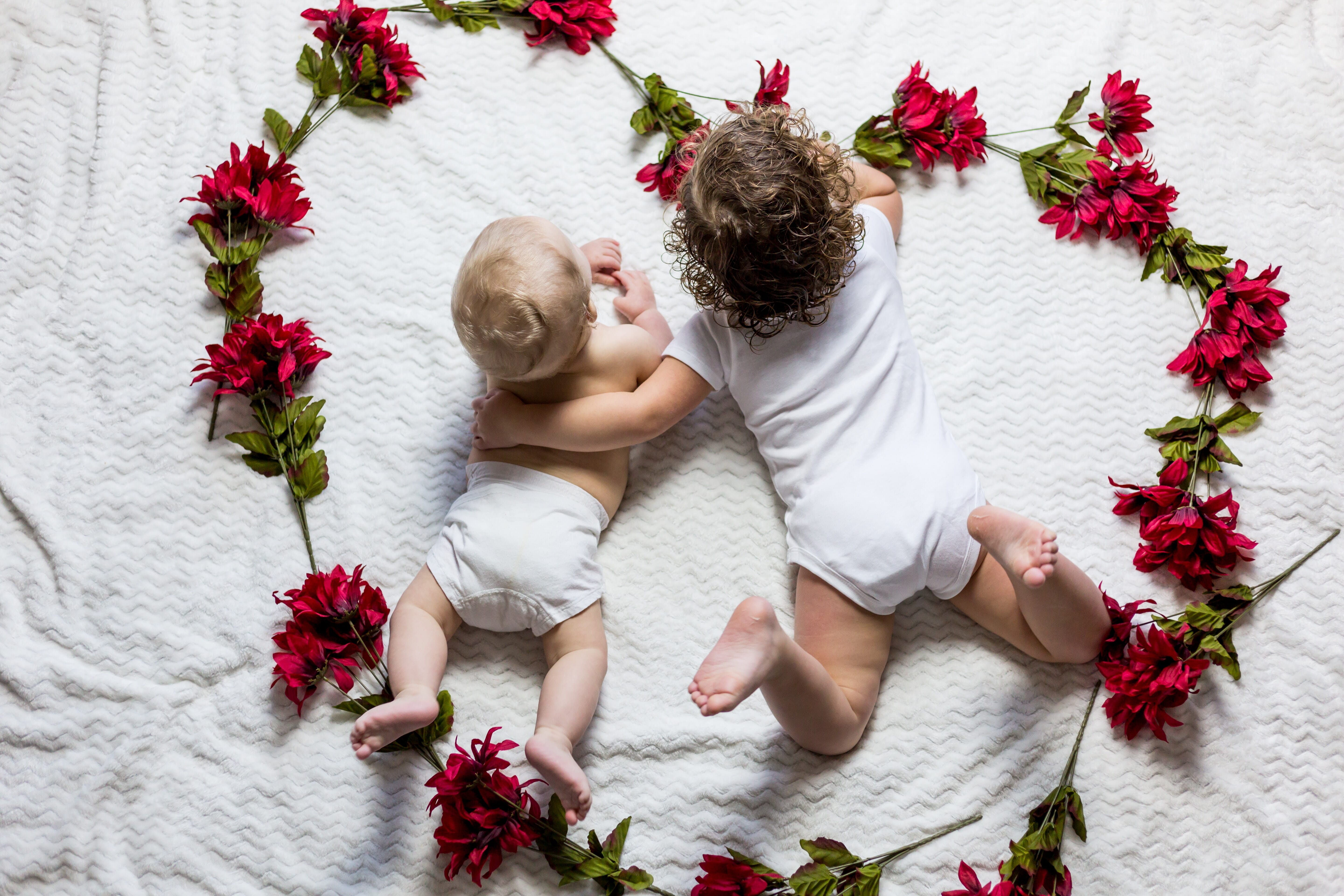 children on valentine's day surrounded by heart of flowers