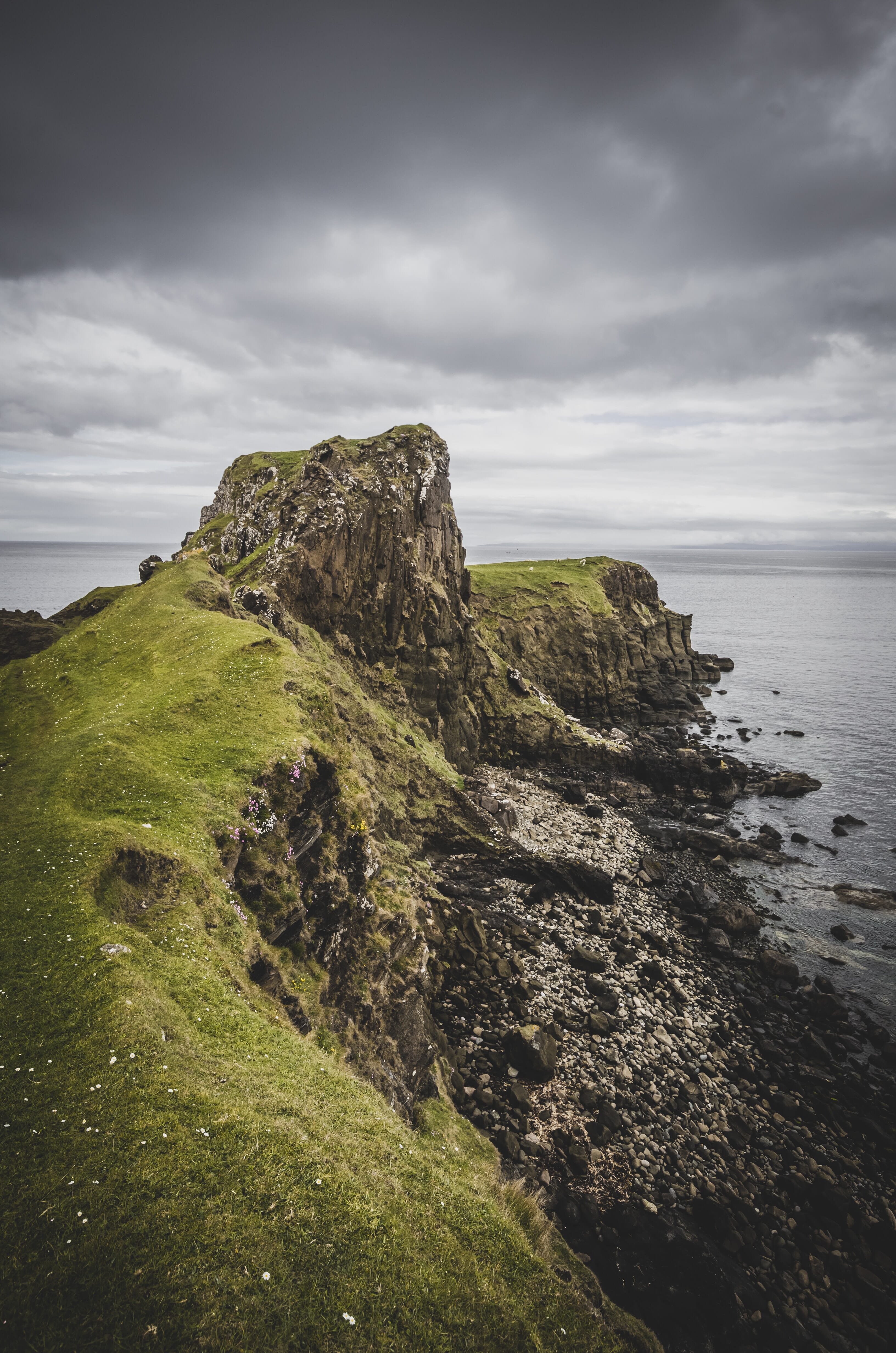 dark cliff with cloudy sky
