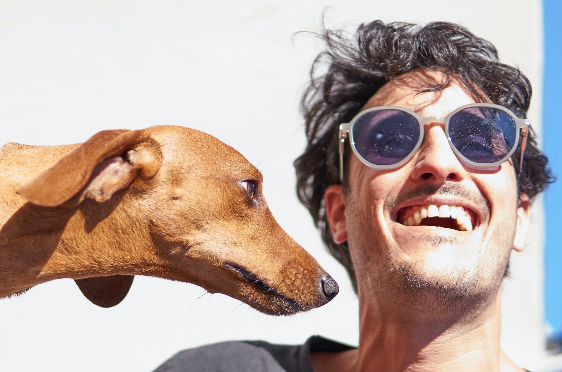 man smiling with pet dog