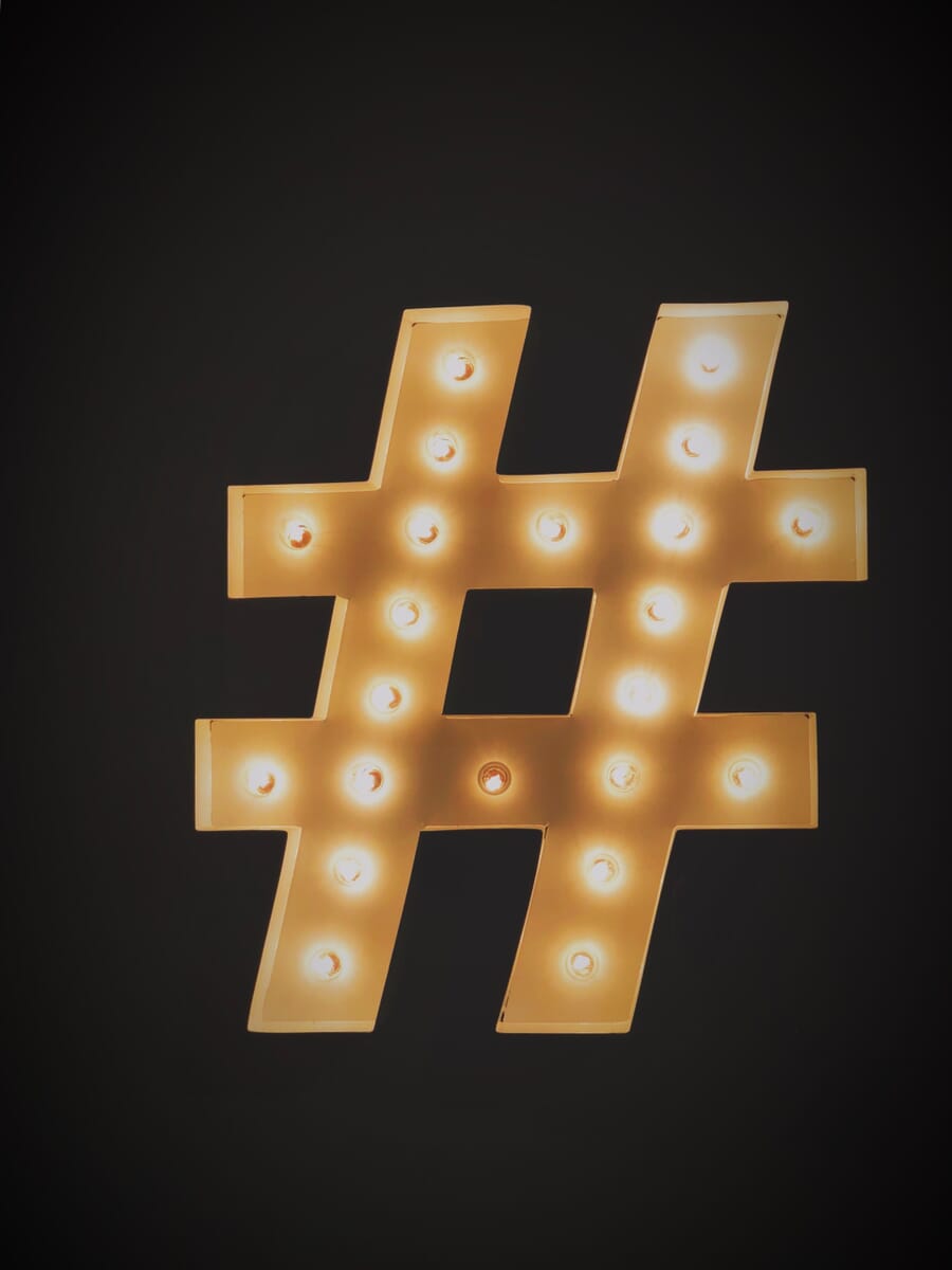 illuminated hashtag sign on a black background