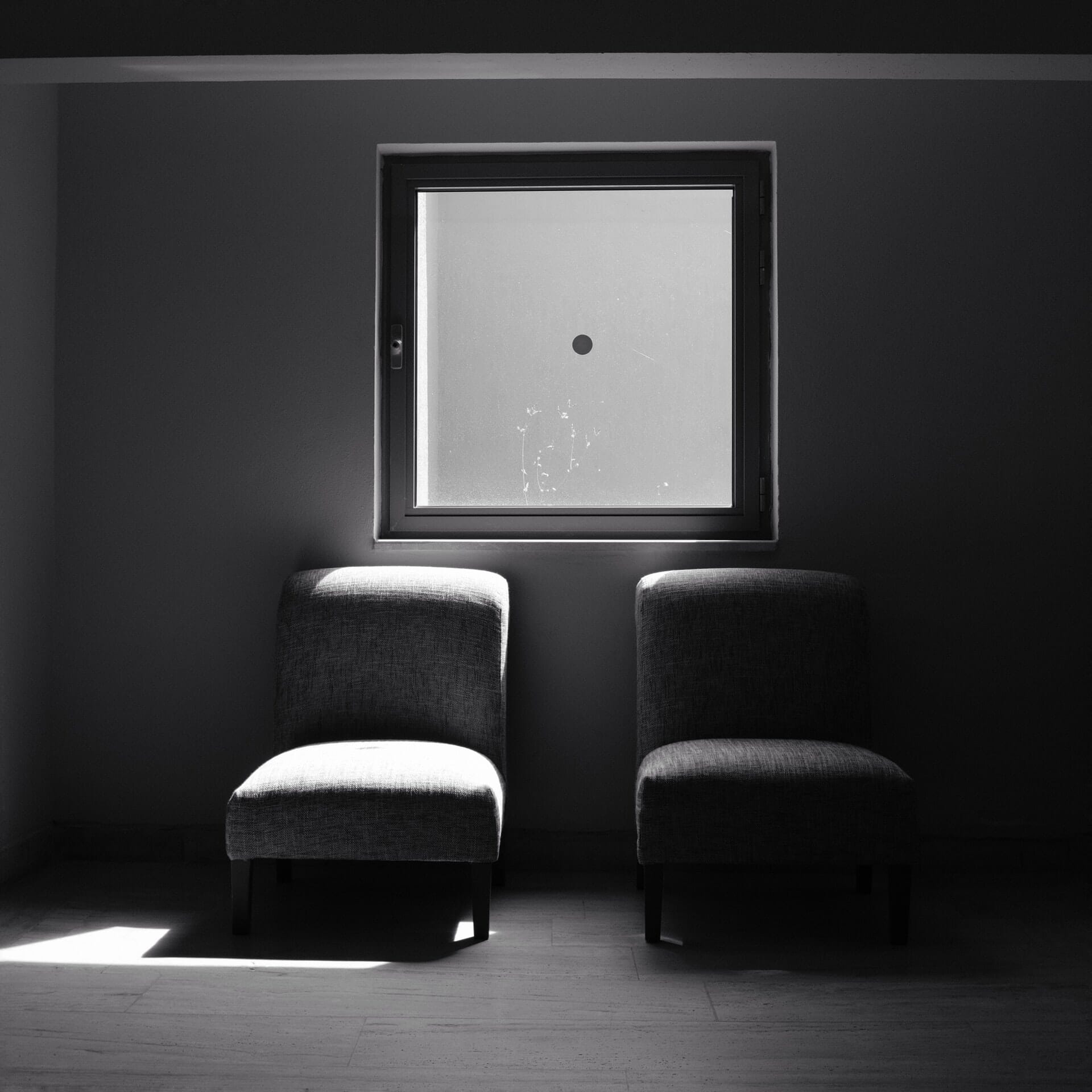 Black and white chairs under a window