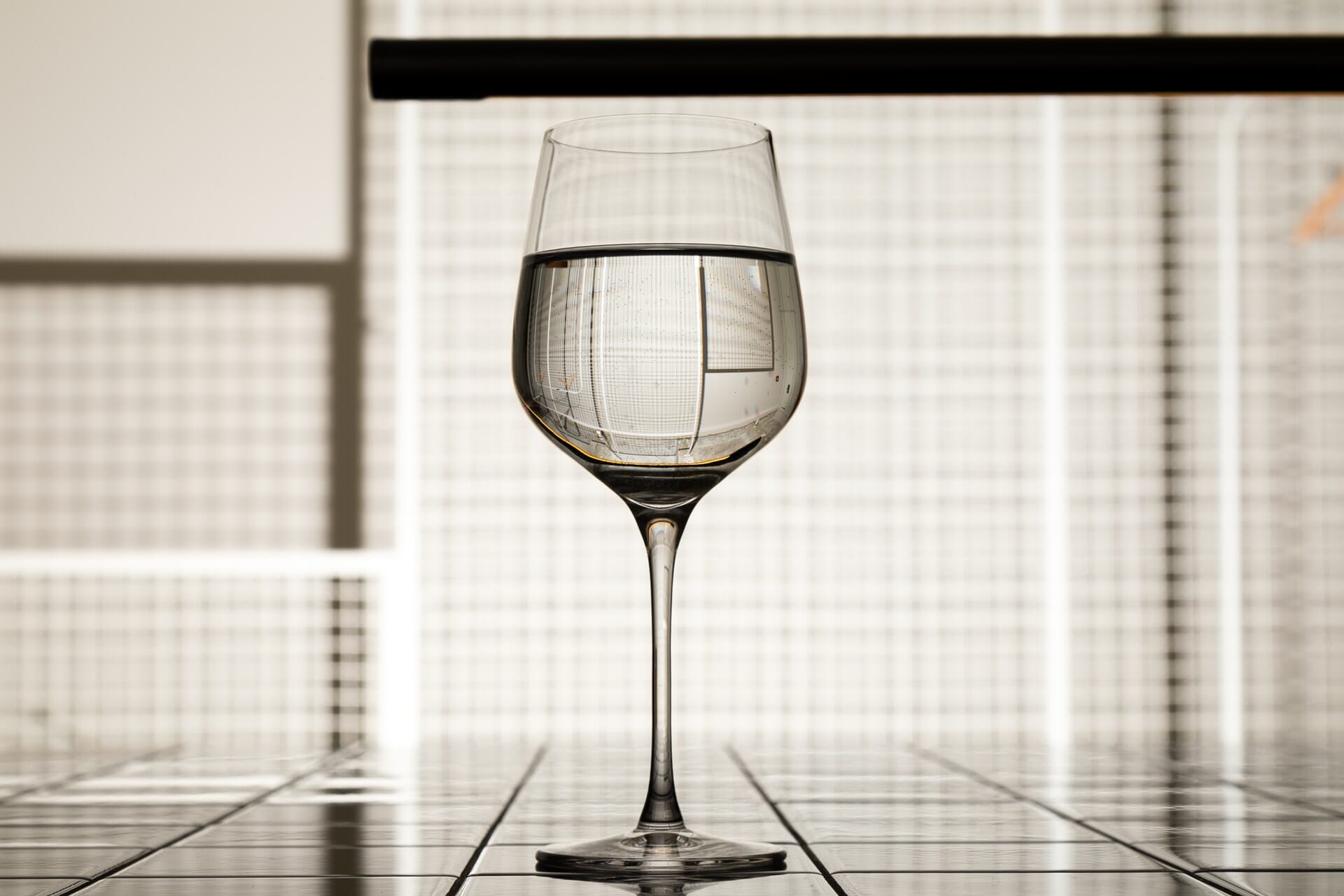 Wine glass with water and a refracted background