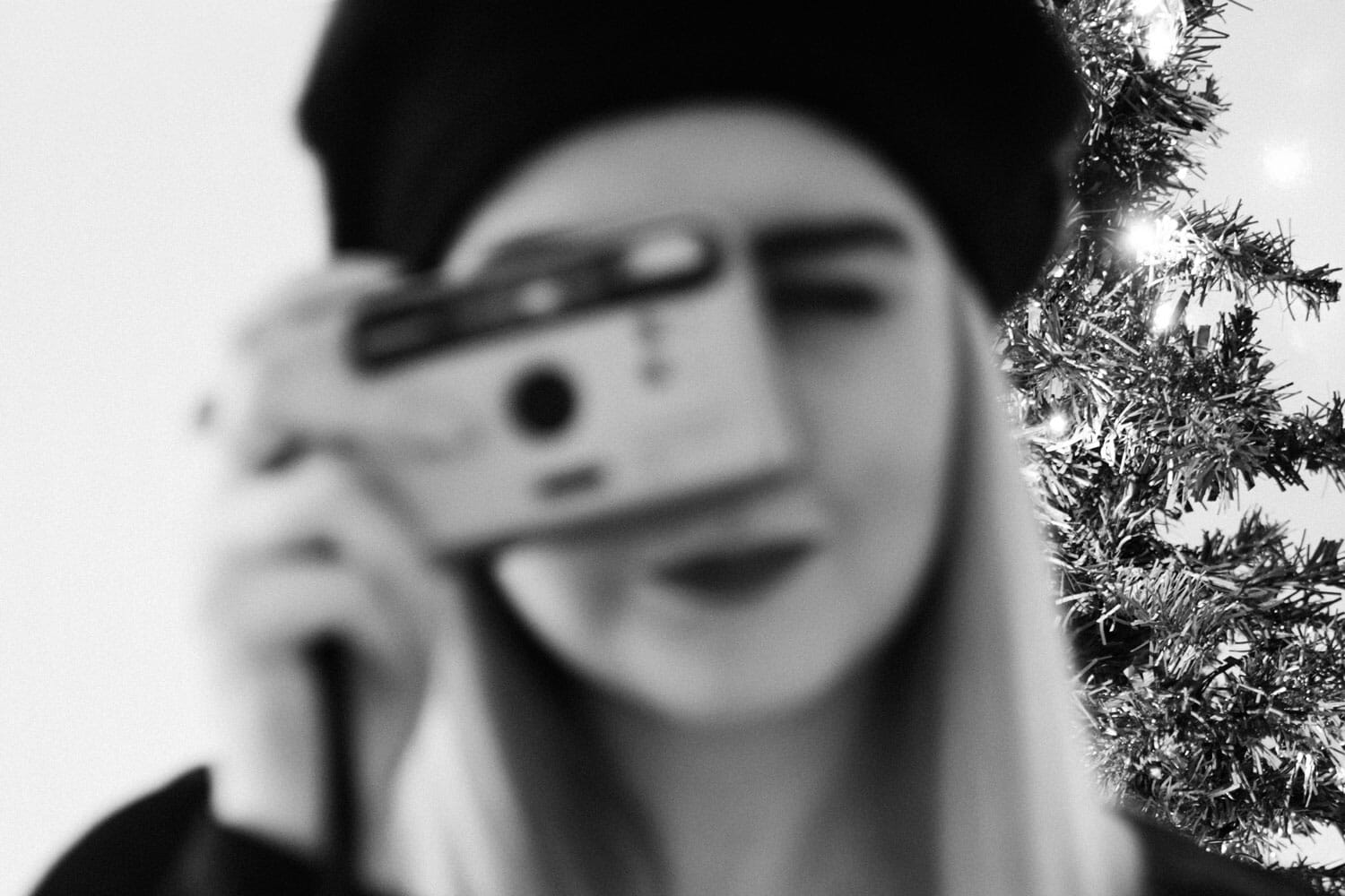 Out of focus woman with a camera