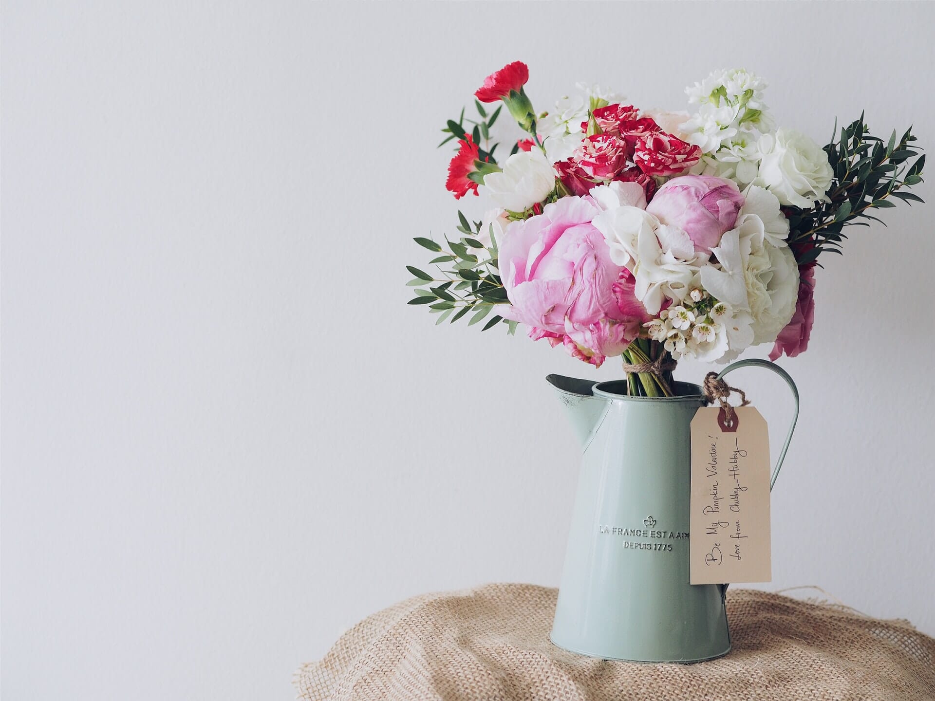 Bouquet of pink, red, and white flowers in a vase