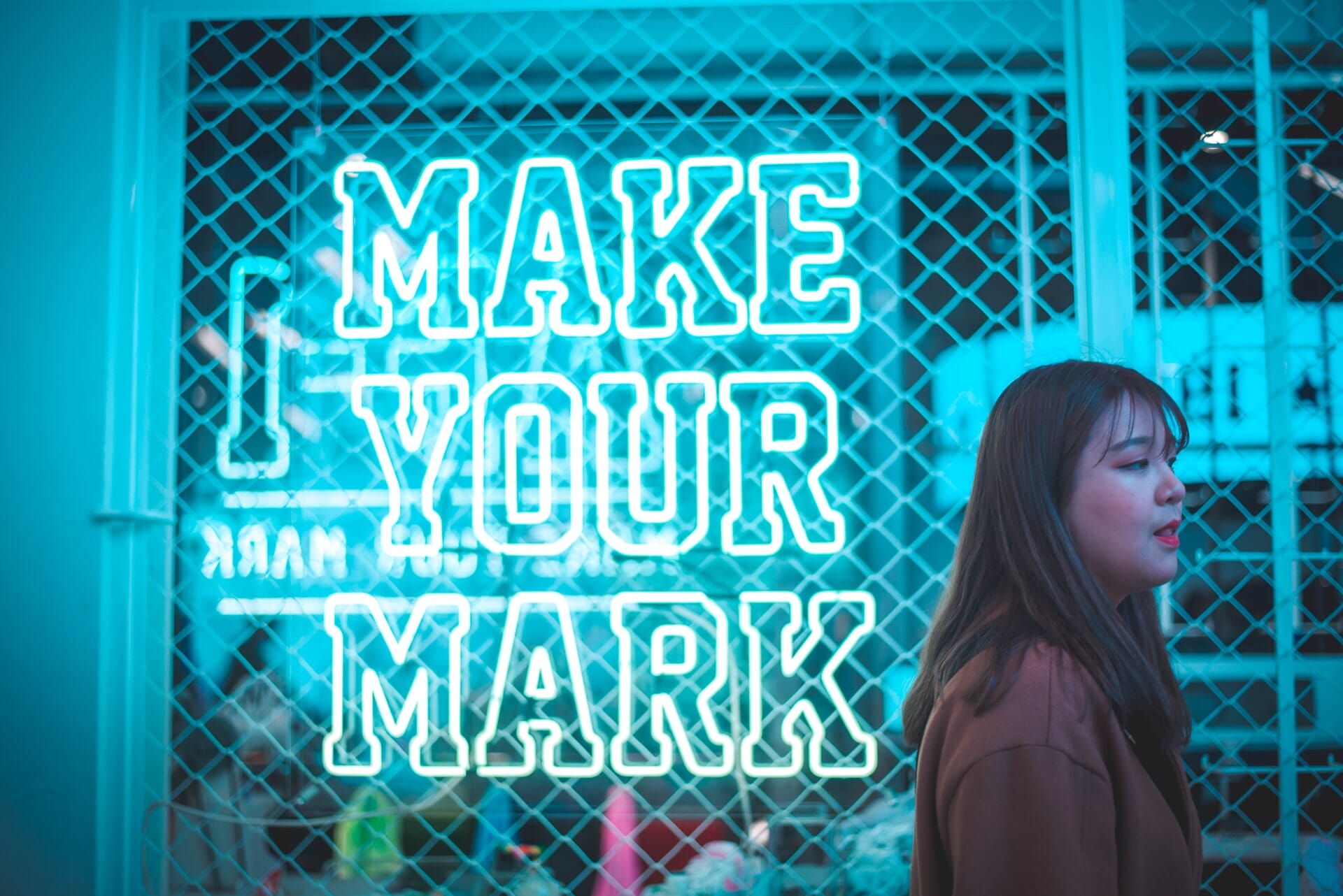 Neon sign that reads, "Make Your Own Mark": personal photography names
