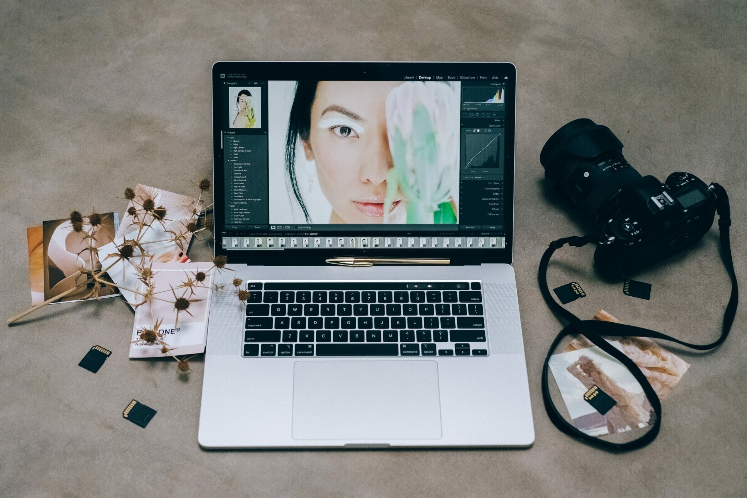 Laptop with lightroom and a camera.