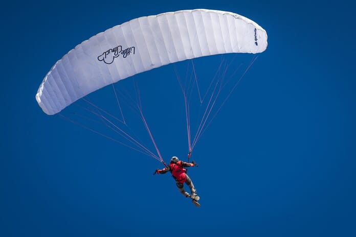 Person taking part in skydiving with a parachute