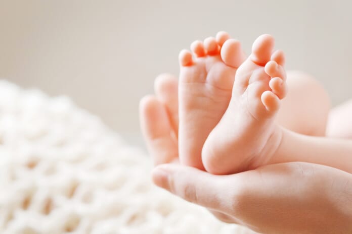 Baby feet in hand
