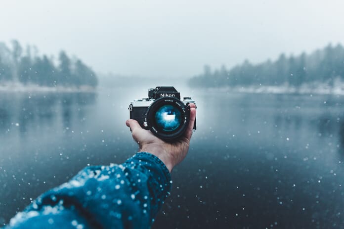 photographer holds out camera
