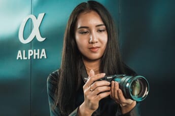 Woman holding a Sony a6400.