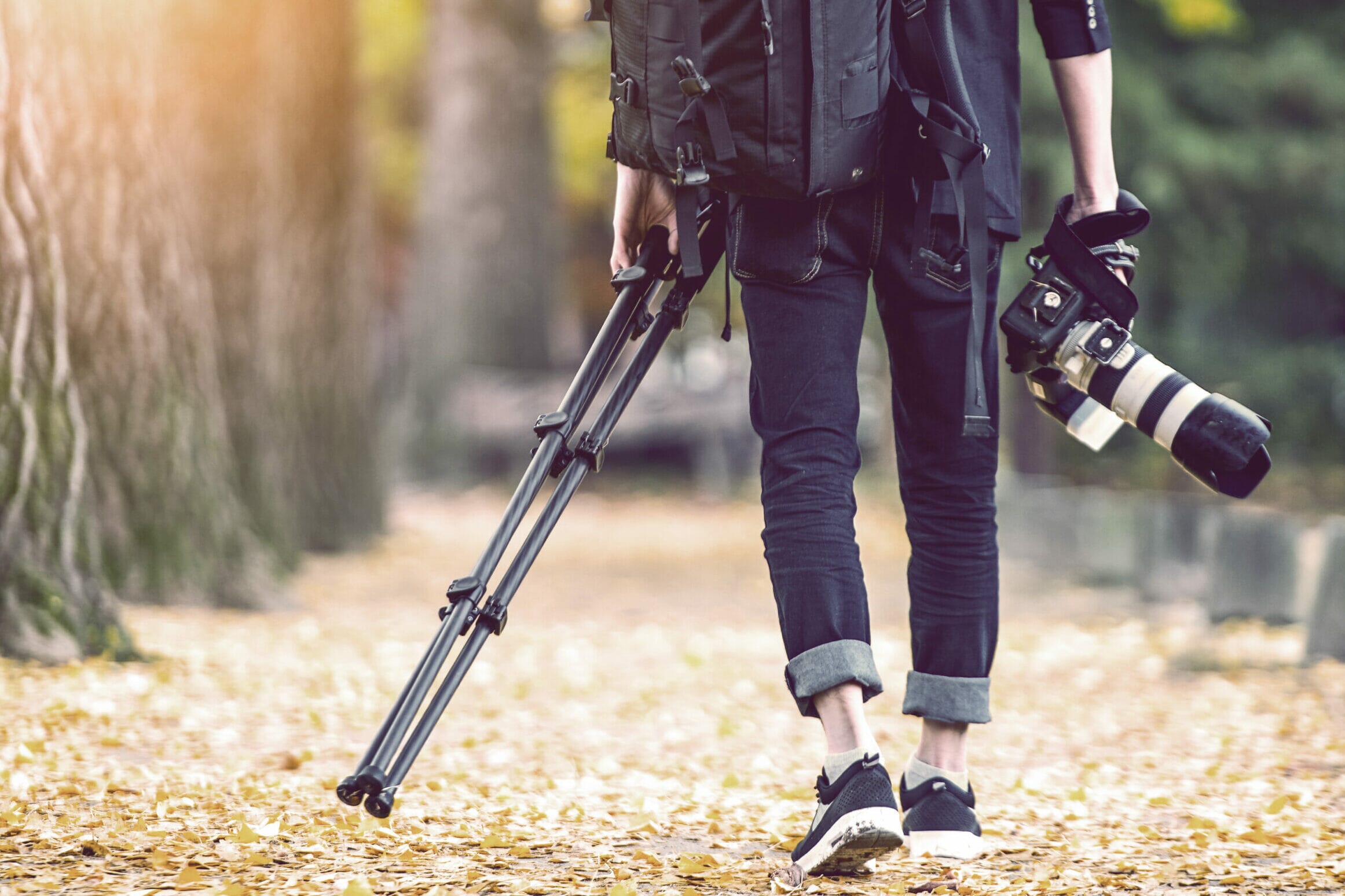 man carrying camera accessories