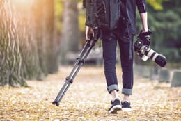 man carrying camera accessories