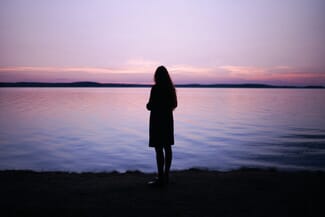 silhouette of women at lake