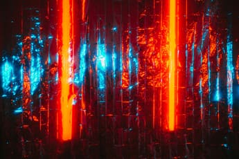 Orange light strips against a silvery foil background with blue reflections.