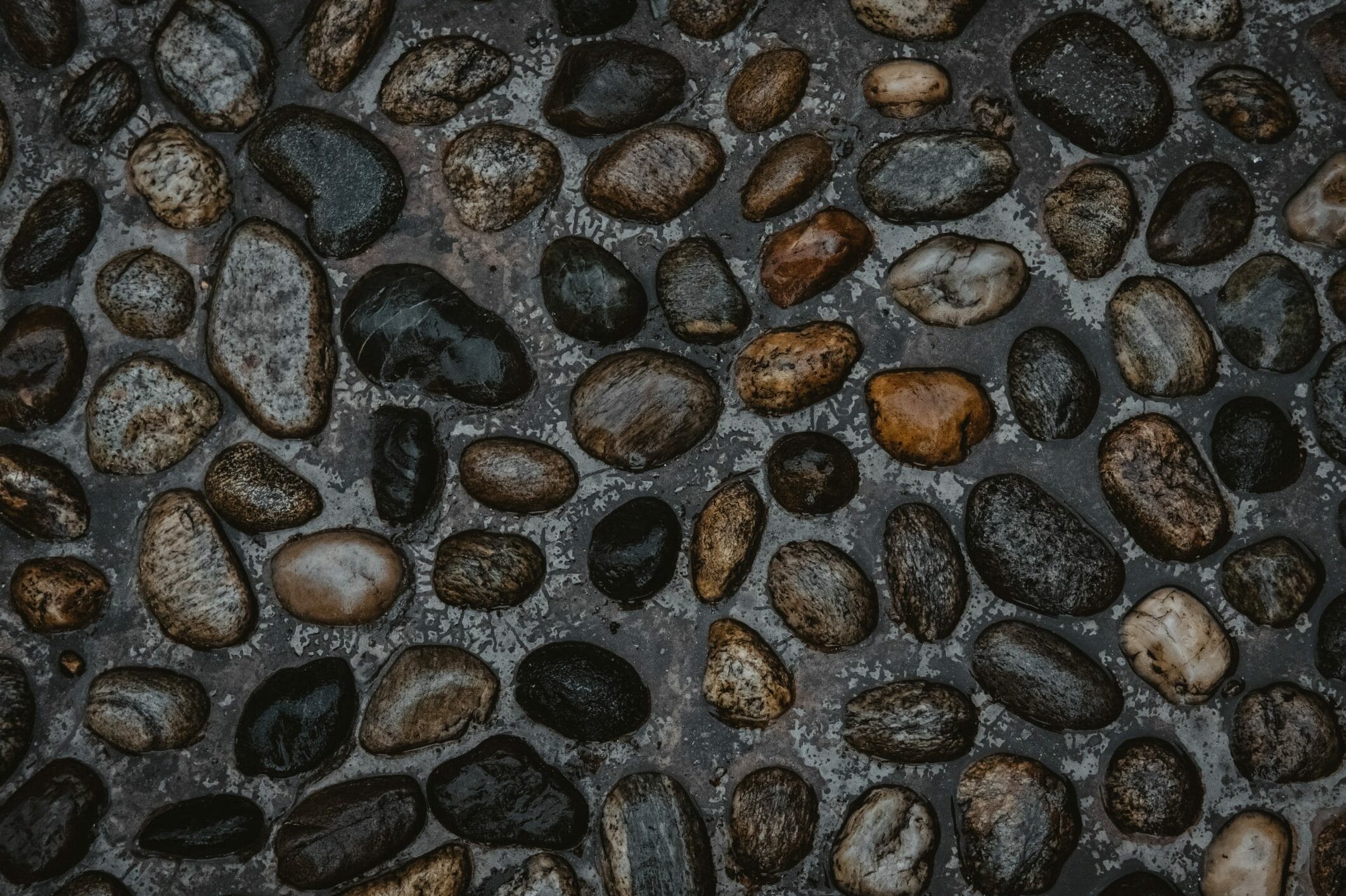 Stones on the road in random patterns.