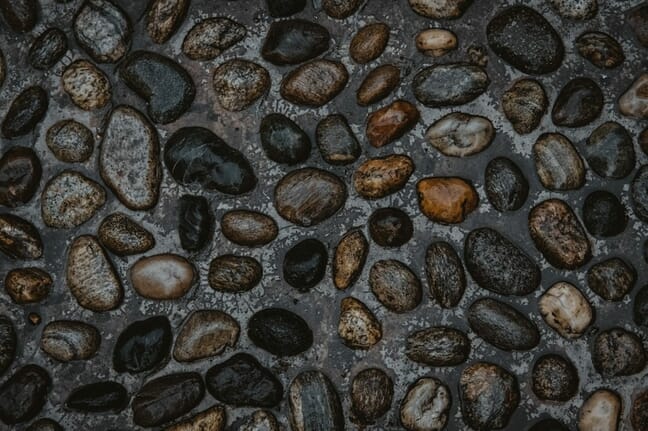 Stones on the road in random patterns.