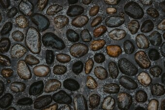 Stones on the road in random patterns.