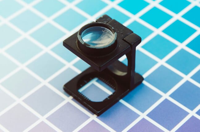 A magnifying glass checking print resolution